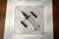 Above image of a navigator\'s radar plotting chart with a triangle and compass divider