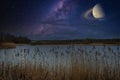 Above  lake is the clear starry sky with the Milky Way and Saturn Royalty Free Stock Photo