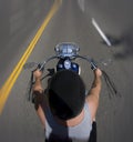 Above passenger view of motorcycle rider driving a street bike