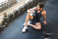 Above photo of fitness man sitting in gym