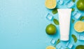 Above photo of pile of limes cubes of ice drops mint and tube of cream isolated on the blue background with blank space Royalty Free Stock Photo