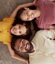 Above portrait of mixed race parents enjoying weekend with daughter in home living room. Smiling hispanic girl hugging Royalty Free Stock Photo