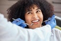 Above shot of a beautiful young african american woman with an afro looking at the dentist at her dental appointment Royalty Free Stock Photo