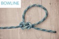 Above shot of hiking rope tied in a knot against a wooden background in studio. Bowline knot. A knot for every situation