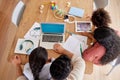 Above shot mixed race family sitting together doing homework and using digital devices at kitchen table. Couple sitting Royalty Free Stock Photo