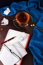 Notebook with blank page, cramped paper, pen, glasses and cup of tea or coffee Royalty Free Stock Photo