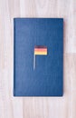 Blue notepad with flag on toothpick