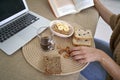 Entrepreneur hands holding snack bar working on laptop Royalty Free Stock Photo