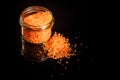 Above small glass jar with pile orange organic sea salt Royalty Free Stock Photo