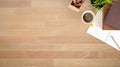 Above table with notebook paper, pencil and coffee on wooden desk with top view