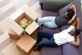 Above view african couple resting on couch on moving day Royalty Free Stock Photo