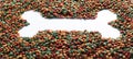 Above or Top view. Colourful Dried dog food with a shape of heart on white background. Grain pet food banner background with copy Royalty Free Stock Photo