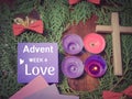 Advent week 4 love text on paper with the purple candle lit background. Advent Season Concept.