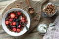 Above view of a berry and granola breakfast bowl served with greek yogurt. Royalty Free Stock Photo