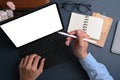 Above view businessman holding stylus pen pointing on screen of computer tablet at office desk. Royalty Free Stock Photo