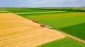 Above view on combine as taking position for transferring freshly harvested cereal into trailer Royalty Free Stock Photo