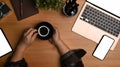 Creative designer holding cup of coffee at his working table. Royalty Free Stock Photo