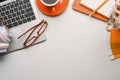 Creative workspace with laptop computer, headphone, glasses, coffee cup and notebook on white table. Royalty Free Stock Photo