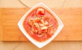 Above view of delicious traditional ecuadorian shrimp cebiche in rectangular white bowl served over a wooden structure