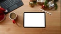 Digital tablet, coffee cup, stylus pen and Christmas gifts on wooden table. Royalty Free Stock Photo