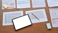 Digital tablet and financial documents on wooden table. Royalty Free Stock Photo