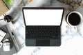 Above view digital tablet with wireless keyboard, coffee cup and supplies on marble table. Top view, feminine workspace Royalty Free Stock Photo