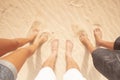 Above view of family legs together enjoying the beach in summer holiday vacation - team people with nude feet on the sand during