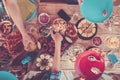 Above view of friends eating together food from the table in pink mood filter colors. Concept of people celebrating and having fun