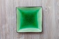 Above view of green square saucer on gray table Royalty Free Stock Photo