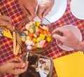 Above view of group of hands taking a fresh fruit salad in the middle of the table. Healthy eating. Tiramisu cheesecake. Red Royalty Free Stock Photo