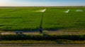 Aerial view on high pressure agricultural water sprinkler, sprayer, sending out jets of water to irrigate corn farm crops Royalty Free Stock Photo