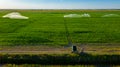 Aerial view on high pressure agricultural water sprinkler, sprayer, sending out jets of water to irrigate corn farm crops Royalty Free Stock Photo