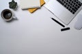 Above view laptop computer, eyeglasses, coffee cup, notebook and succulent plant on white table. Flat lay, Top view Royalty Free Stock Photo