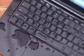 Above view of laptop with water drop damage liquid wet and spill on keyboard, accident concept Royalty Free Stock Photo