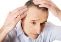 Above view of a man examining his hair Royalty Free Stock Photo