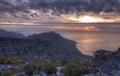 Above view of a mountain coastline at sunset in South Africa. Scenic landscape of dark clouds over a calm and peaceful Royalty Free Stock Photo