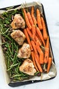 Above view of a pan of roasted chicken thighs with roasted vegetables.