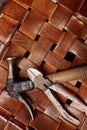 Above view of part of brown wicker stool and set of handtools