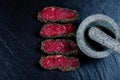 Above view on Pepper steaks on stone with mortar bowl pestle Royalty Free Stock Photo