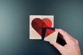 above view of person piecing together heart shape on wooden blocks