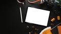 Photographer workspace with digital tablet, camera, coffee cup and stylus pen on black leather. Royalty Free Stock Photo