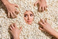Above view portrait of horrified nervous person look crawling zombie arms face buried isolated in pop corn background