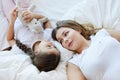 Mother and Daughter Lying on Bed