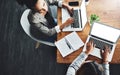 Above view of professional employees talking and working together on a strategy project on their laptop in a modern Royalty Free Stock Photo