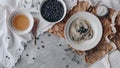 Above view of the rustic composition of the cup of tea, plate full of blueberries and the breakfast food. Royalty Free Stock Photo