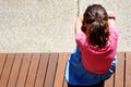 Above view of sad young girl covering her face and crying in school yard