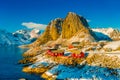 Above view of some Fishing hut rorbu and Lilandstinden mountain peak at sunset - Reine, Lofoten islands, Norway Royalty Free Stock Photo