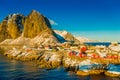 Above view of some Fishing hut rorbu and Lilandstinden mountain peak at sunset - Reine, Lofoten islands, Norway Royalty Free Stock Photo