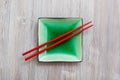 Above view square saucer with chopsticks on gray Royalty Free Stock Photo