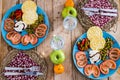 Above view of table with two dishes full of vegetables and diet healthy food on a wooden trendy table -coloured mix of tasty and Royalty Free Stock Photo